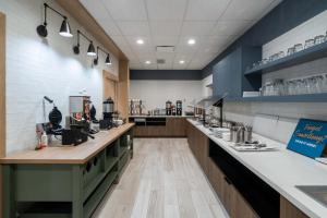 a large kitchen with a counter and a bar at Staybridge Suites - Flowood - NW Jackson, an IHG Hotel in Flowood