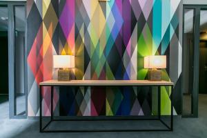 a room with two lamps on a colorful wall at Roombach Hotel Budapest Center in Budapest