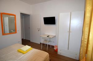 Un dormitorio con una cama, un escritorio y un espejo. en Roma Sister, en Roma