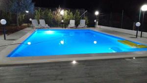 Debel house في مارينا دي راغوزا: حمام سباحة أزرق كبير في الليل
