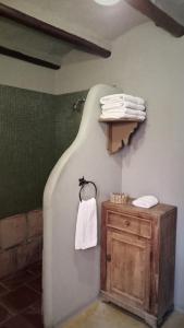 a bathroom with a white towel hanging on a wall at Miraluna Bodega Boutique in Cachí