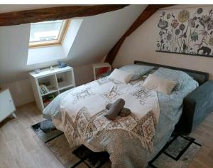 a bedroom with a large bed in a attic at Orléans centre T2 théâtre et cathédrale in Orléans