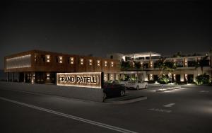 a sign in a parking lot in front of a building at GRAND PATELLI in Myrina