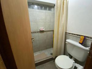 a small bathroom with a toilet and a shower at Casa Cafayate in Cafayate +28 photos