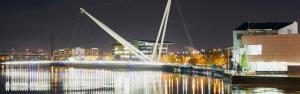 a bridge over a river at night with buildings at Newly rennovated 1-bedroom serviced apartment, walking distance to Hospital or Train Station in Newport