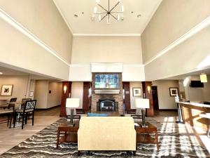 a lobby with a living room with a fireplace at Staybridge Suites Detroit-Novi, an IHG Hotel in Novi