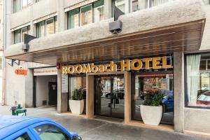 a hotel sign on the front of a building at Roombach Hotel Budapest Center in Budapest