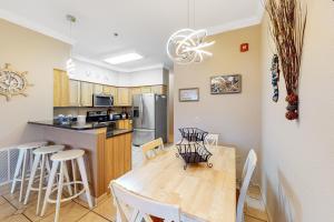 a kitchen and dining room with a table and chairs at Ohana KDH122 in Kill Devil Hills