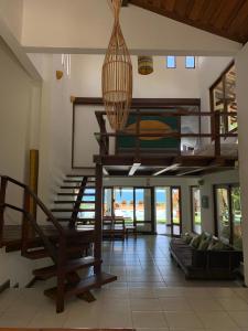 a living room with a spiral staircase in a house at Casa Buena Vista in Arraial d'Ajuda +69 photos