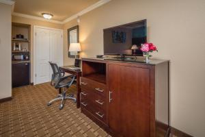 a hotel room with a desk and a chair at Stage Coach Lodge in Monterey