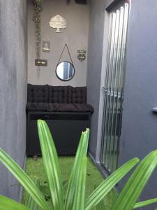 a room with a couch and a mirror and a plant at LOFT RIO in Rio de Janeiro