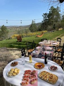 a table with plates of food on it at Maison Colette au coeur du périgord noir in Montignac