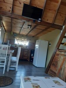 a kitchen with a refrigerator and a table and chairs at Tierra de Inmigrantes in Baradero