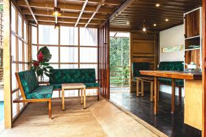 ein Wohnzimmer mit einem Tisch und grünen Stühlen in der Unterkunft The Mimosas - Beautiful Unique Container Homes with Pool in Hone Creek + 20 Fotos