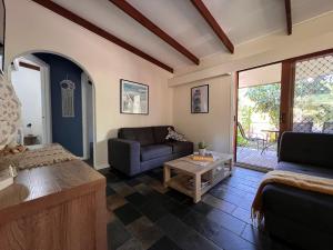 a living room with a couch and a table at Colonial Village Resort in Hervey Bay