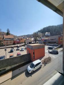 a white car is parked in a parking lot at KM2 Apartment in Triberg
