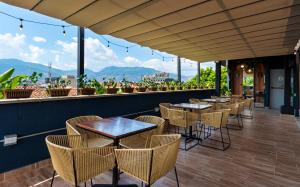 a row of tables and chairs on a patio at Manila Hotel Boutique in Medellín