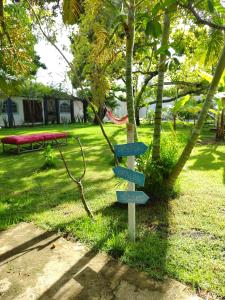 Villa Ostello Pousada في باريبويرا: وجود علامة في حديقة عليها لافتات الشارع