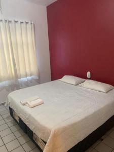 a bedroom with a large bed with two towels on it at Amarante Hotel in Juazeiro