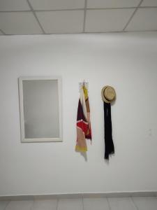 a white wall with a window and a hat on it at Departamento Temporario in Resistencia