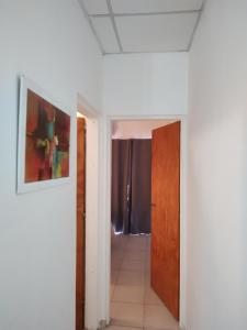 a hallway with a door and a room with a tile floor at Departamento Temporario in Resistencia