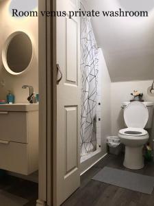 a bathroom with a toilet and a sink at Cheerful residence in Niagara Falls
