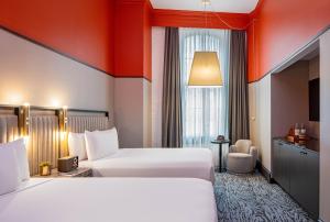 Ένα ή περισσότερα κρεβάτια σε δωμάτιο στο Pelham Hotel