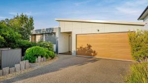 a house with a wooden garage door at Bliss on Sanctuary in Cowes