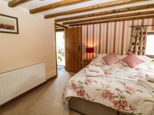 a bedroom with a large bed and a window at Meadow View in Edale