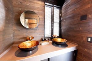 two sinks in a bathroom with wooden walls at VILLA HAKONE湖空 in Hakone +89 photos