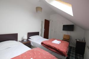 
Кровать или кровати в номере Tartan Lodge
