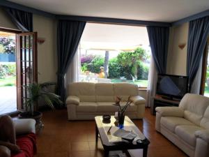 a living room with two couches and a tv at Villa Sara B&B in Civitavecchia