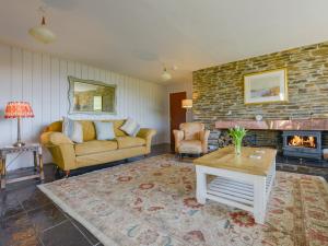 a living room with a couch and a fireplace at Ayrmer House in Bigbury