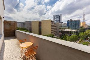 - Balcón con 2 sillas y mesa en Cobertura Jardins | AC | Garagem, en São Paulo