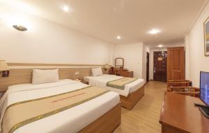 Rúm í herbergi á Vietsovpetro Hotel Dalat