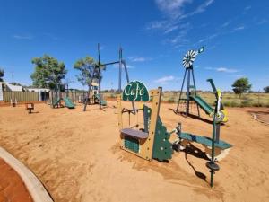 an empty playground with slides and swings at Erldunda Desert Oaks Resort in Erldunda