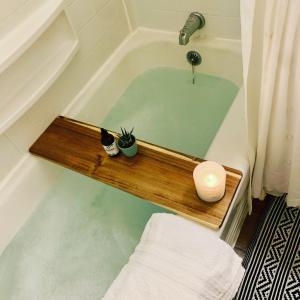 un bagno con una vasca da bagno con due piante dentro di Casa Agave: Comfy Joshua Tree Cottage With Free Breakfast Bar a Joshua Tree