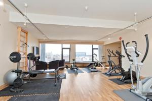 a gym with treadmills and exercise equipment in a building at Thon PartnerHotel Saga in Haugesund