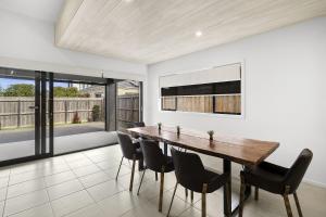 a dining room with a wooden table and chairs at Lowtide Five Bedroom 22 in Torquay