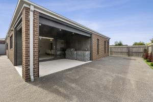a large open garage with a couch in it at Lowtide Five Bedroom 22 in Torquay