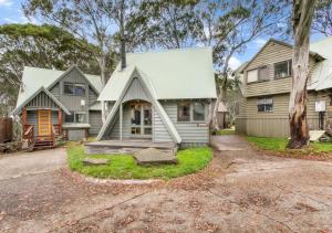 a house with a porch and a driveway at Coolong in Dinner Plain