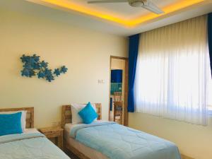 Ein Bett oder Betten in einem Zimmer der Unterkunft Ocean Star Apartment Sanur