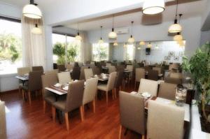 a restaurant with a dining room with tables and chairs at Hotel Santa Maria in Saint-Florent