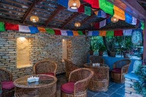 
a patio area with chairs, tables, and umbrellas at Hotel Silver Oaks Inn in Pokhara
