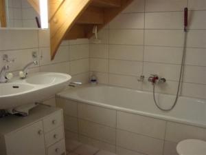 a bathroom with a sink and a bath tub at Chalet Verano in Grimentz