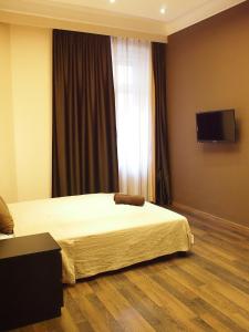 una camera con letto e TV a schermo piatto di Budapest Suites a Budapest