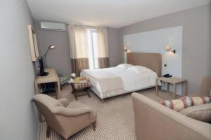 a bedroom with a bed and a living room at Hotel Santa Maria in Saint-Florent