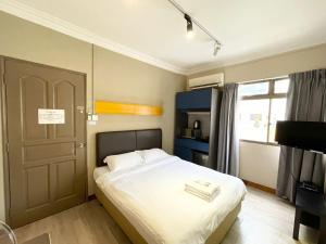 a small bedroom with a bed and a door at Greatwood Residence at Devonshire in Singapore