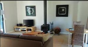 sala de estar con sofá y fogones en Island Break Cottages, en Cowes