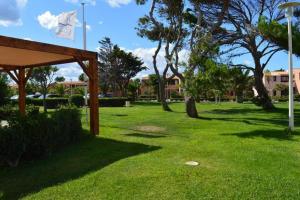 a park with green grass and trees and a pavilion at Résidence naturiste Aphrodite appartement 940 in Leucate